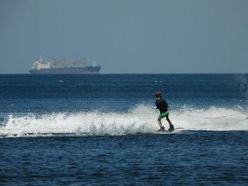 Man on sea against clear sky