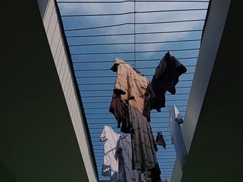 Clothesline hung on an iron trellis with a bright blue sky as a background