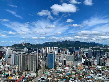 High angle view of modern buildings in city against sky