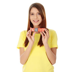 Portrait of a smiling young woman against white background