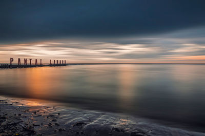 Scenic view of sea against sky at sunset