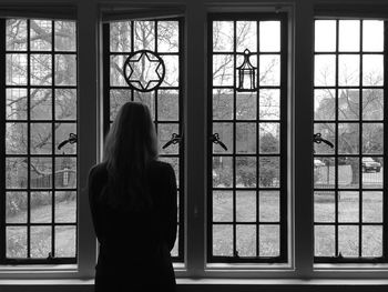 Woman looking through window