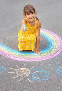 Rear view of girl playing with water