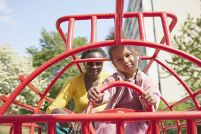 Portrait of mother and daughter having fun playing in playground