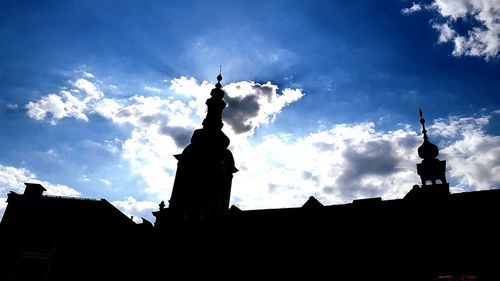 Low angle view of silhouette temple against sky