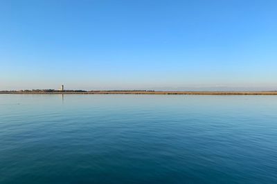 Scenic view of sea against clear blue sky