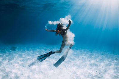 Rear view of woman skiing on snow