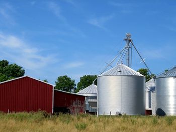 Storage compartments on grassy field against sky