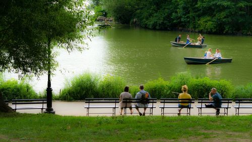 Man sitting on bench in lake
