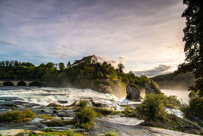 Scenic view of waterfall against sky