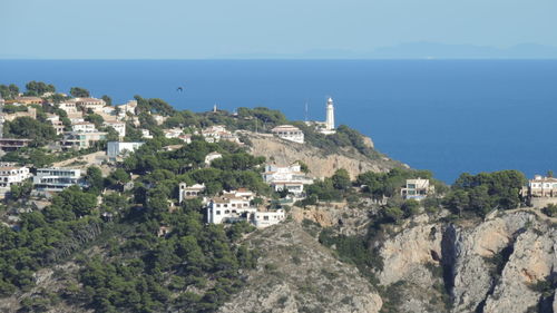 Scenic view of sea and buildings against sky
