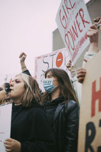 Female activist participating in anti-racism protest during pandemic