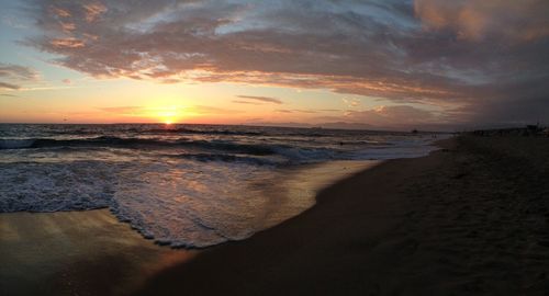 Scenic view of beach against sky during sunset