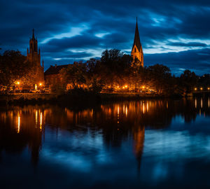 Reflection of illuminated building on water at night