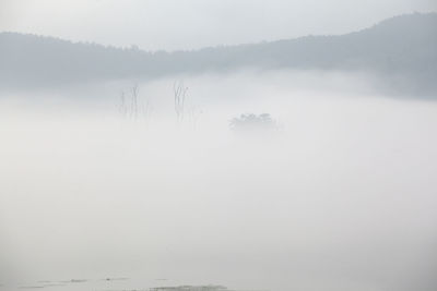 Scenic view of mountains in foggy weather