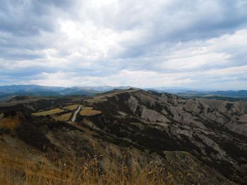 Scenic view of mountains against cloudy sky