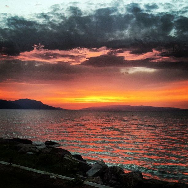 sunset, water, scenics, tranquil scene, sky, beauty in nature, tranquility, sea, orange color, cloud - sky, idyllic, nature, cloud, dramatic sky, lake, cloudy, reflection, mountain, dusk, horizon over water