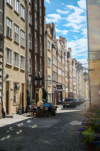 Street amidst buildings in city against sky
