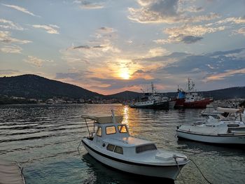 Boats in marina at sunset