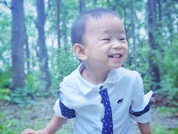 Portrait of smiling boy in forest