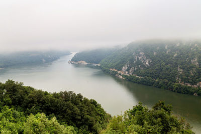 High angle view of river amidst trees against sky