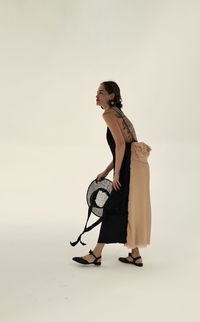 Young woman standing against white background