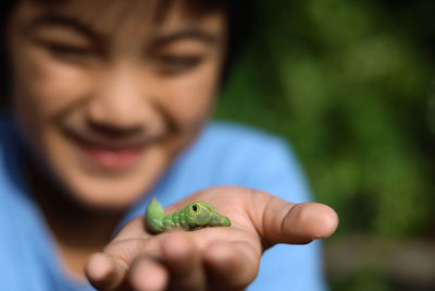 Portrait of boy holding leaf
