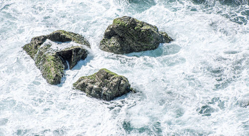 High angle view of rocks in sea