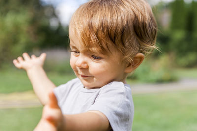 Close-up of innocent boy on field