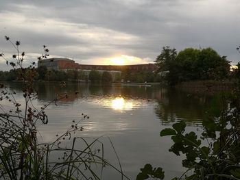 Scenic view of lake against sky at sunset