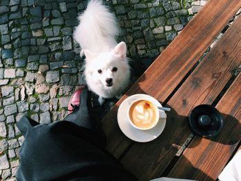 Coffee cup on wooden table outdoors 