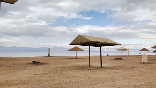 Lifeguard hut on beach against sky