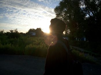 Man in park against sky during sunset