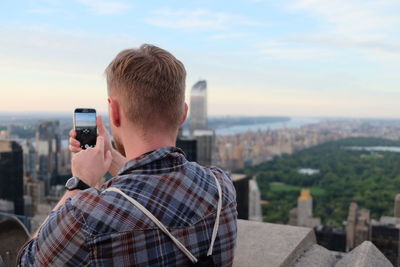 Woman photographing through smart phone