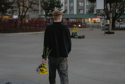 Rear view of woman walking on street