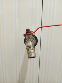 Close-up of electric lamp hanging on wall