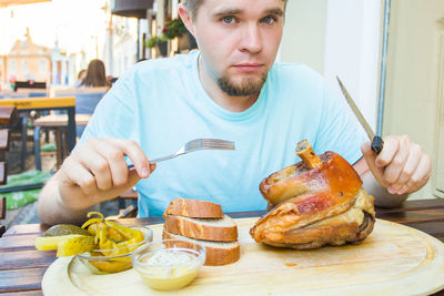 Man eating food on table