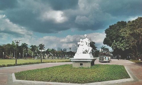 Statue in park against sky