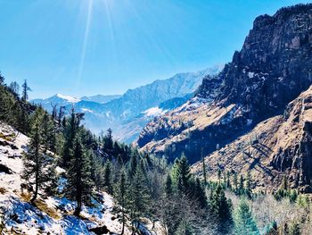 Scenic view of snow covered mountains against sky