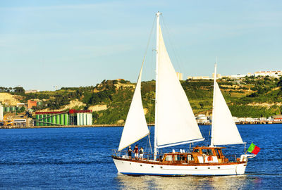 Boat in river against landscape