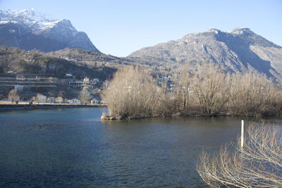 Scenic view of lake and mountains against clear sky