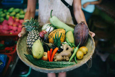 Midsection of person holding fruits