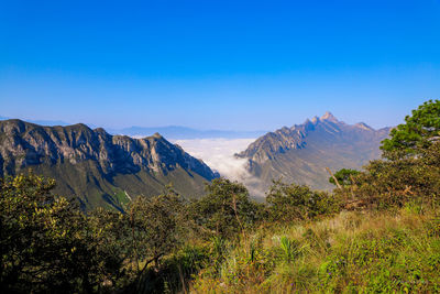 Scenic view of mountains against clear blue sky