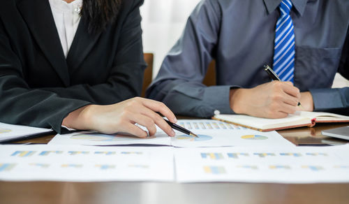 Midsection of business colleagues working at office