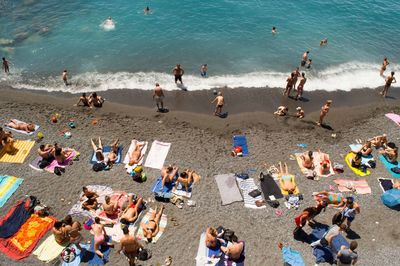 High angle view of people relaxing on beach