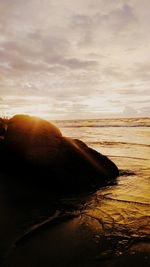 Scenic view of beach against sky during sunset