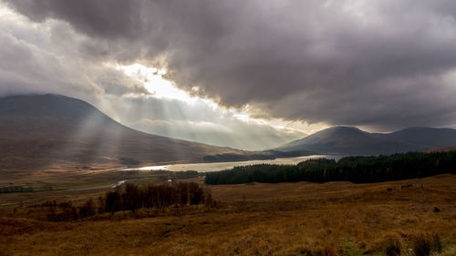 Scenic view of mountains against cloudy sky