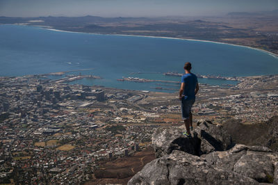 High angle view of man standing on rock