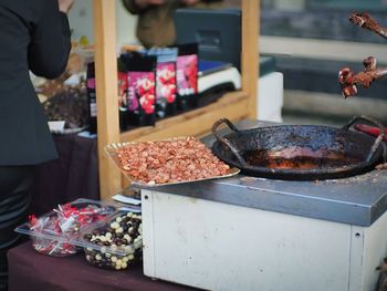 Cropped hand of man preparing food