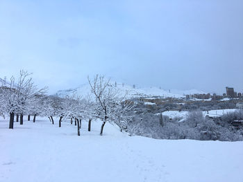 Snow covered field against sky